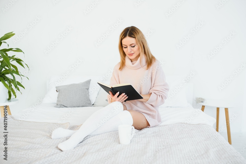 beautiful woman reading book in the bed. Relaxing concept beautiful woman reading book in the bed. Relaxing concept