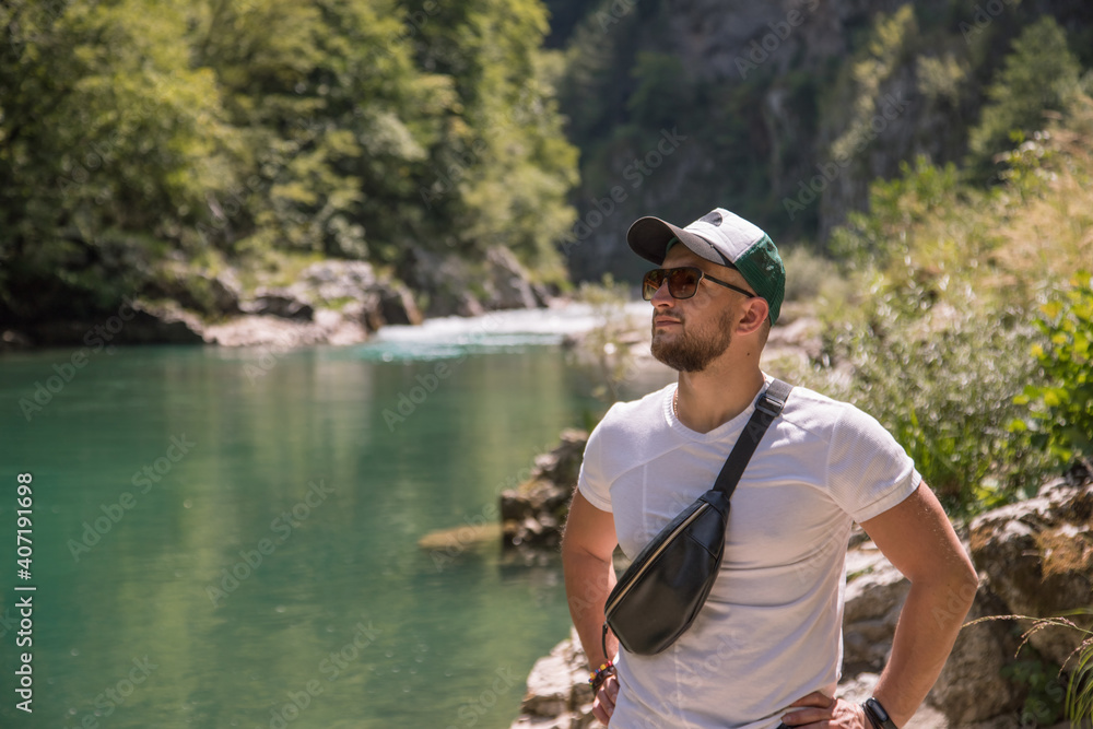 Portrait of handsome stylish man on walk near riverside. Canyon Tara , Montenegro. Portrait of handsome stylish man on walk near riverside. Canyon Tara , Montenegro.