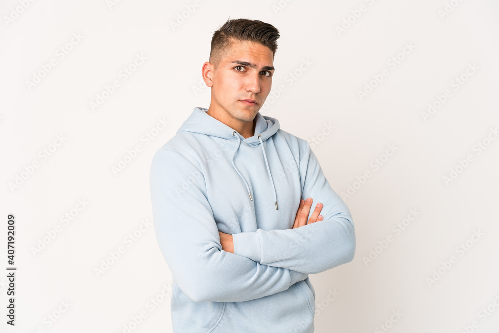 Young caucasian handsome man isolated suspicious, uncertain, examining you. Young caucasian handsome man isolated suspicious, uncertain, examining you.