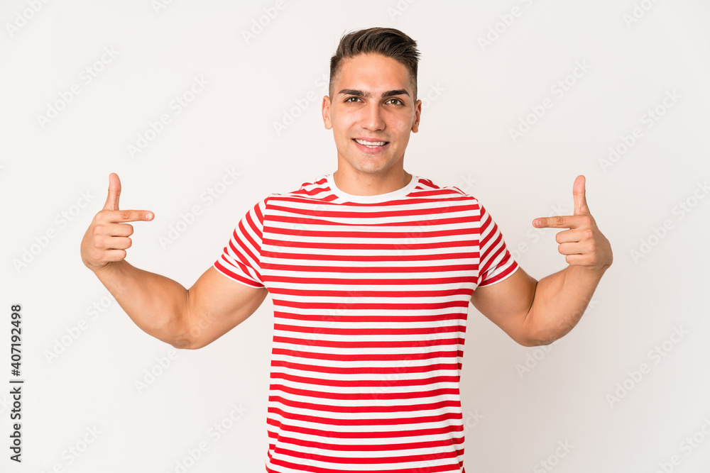 Young caucasian handsome man isolated points down with fingers, positive feeling. Young caucasian handsome man isolated points down with fingers, positive feeling.