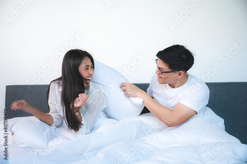 young couple living fun on the bed in bedroom at home, romance date and love concept for Valentine's Day