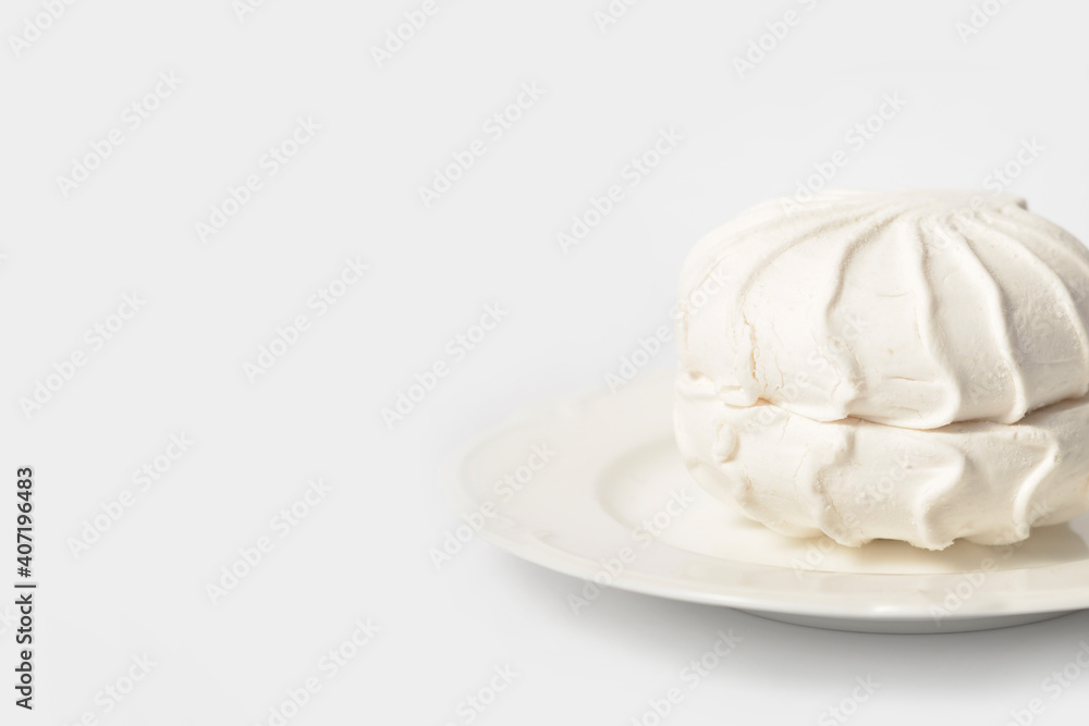 Russian traditional marshmallow dessert zefir souffle served on plate isolated on light background
