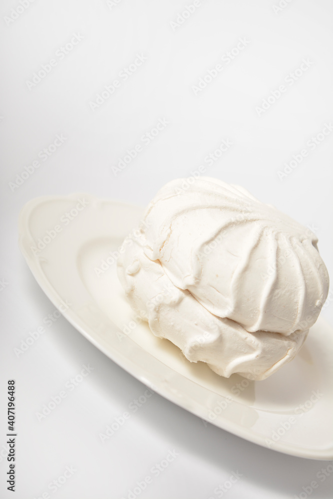 Side view of Russian organic marshmallow dessert zefir souffle served on plate isolated on light background. Dessert made of apple pectin, egg whites
Side view of Russian organic marshmallow dessert zefir souffle served on plate isolated on light background. Dessert made of apple pectin, egg whites