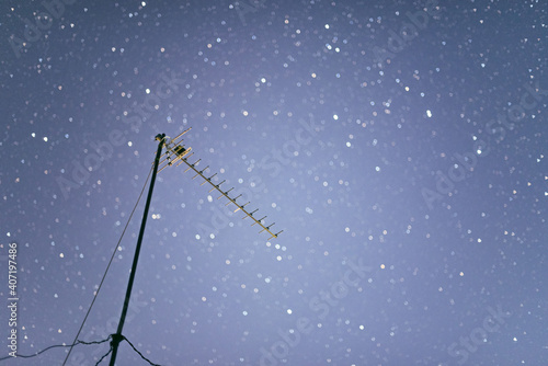 satellite dish on blue sky stars background