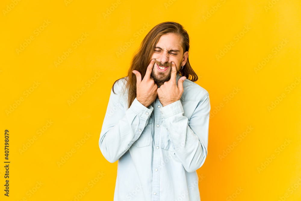 Young man with long hair look doubting between two options. Young man with long hair look doubting between two options.