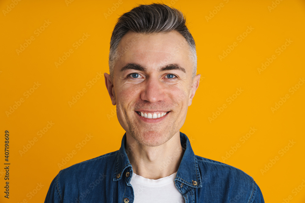 Joyful handsome man smiling and looking at camera