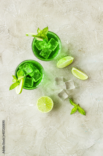 Glasses of iced mojito or lemonade with lime and mint