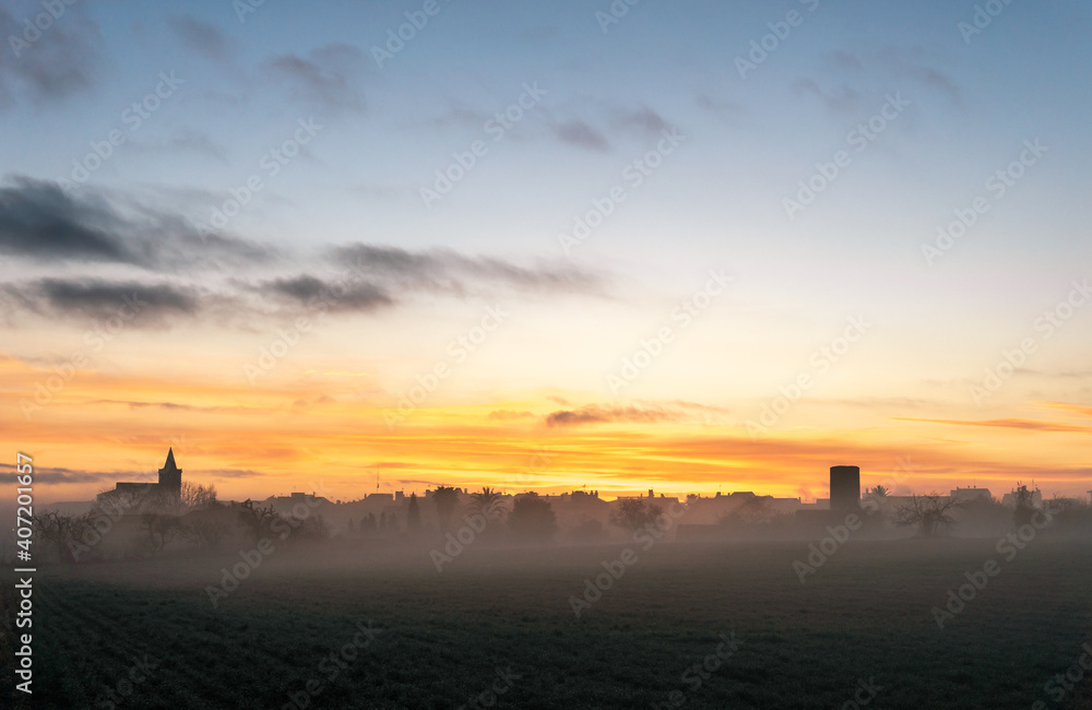 General view of a sunrise in the Majorcan town of Porreres in winter with fog