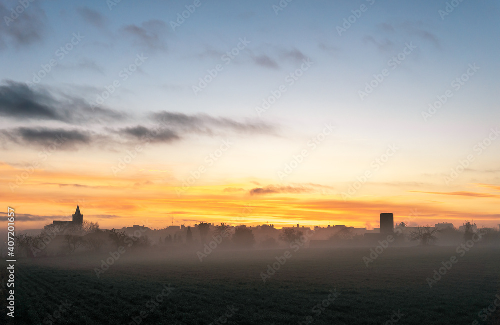 General view of a sunrise in the Majorcan town of Porreres in winter with fog General view of a sunrise in the Majorcan town of Porreres in winter with fog