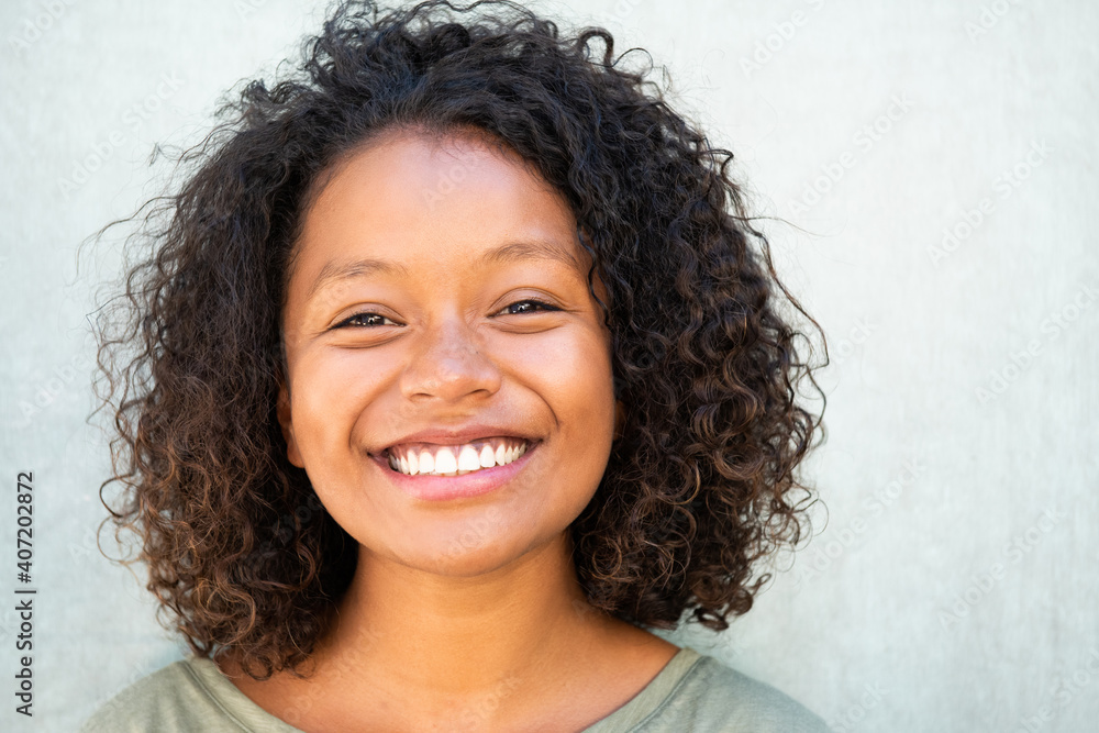 Close up cute African American woman with curly hair smiling - obrazy, fototapety, plakaty 