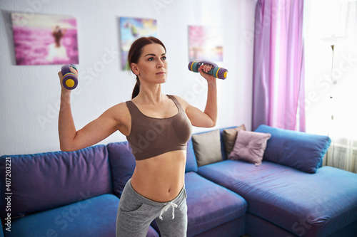 Fit woman training with weights at home