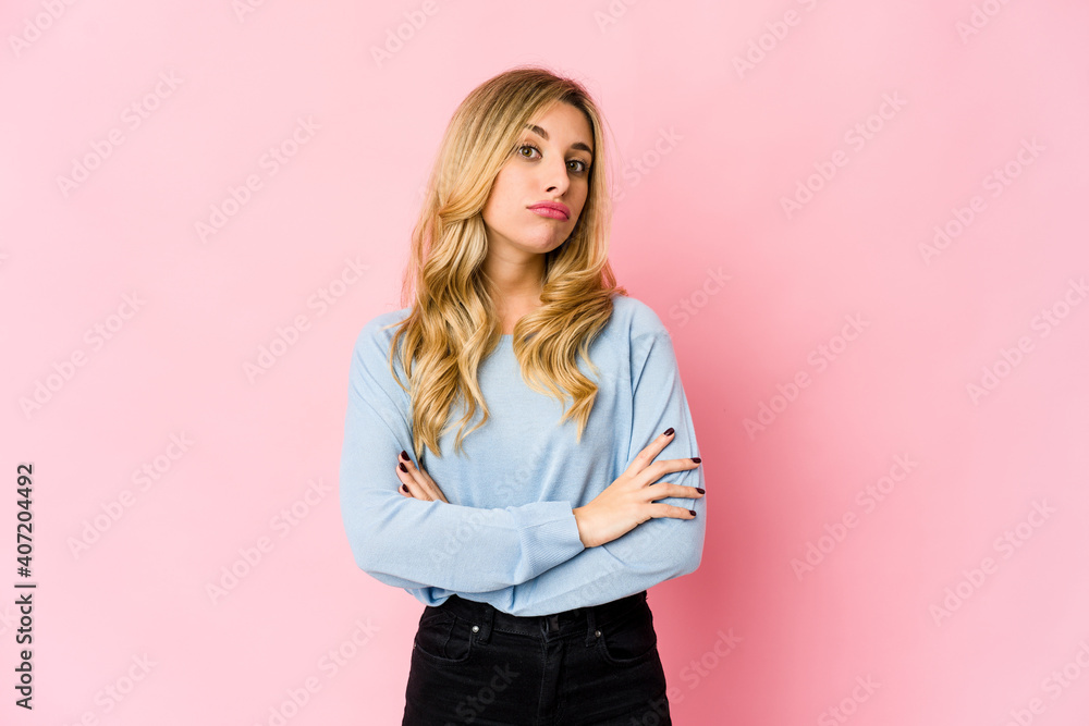Young caucasian blonde woman tired and very sleepy keeping hand on head. Young caucasian blonde woman tired and very sleepy keeping hand on head.