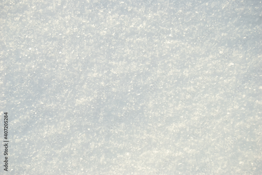 The texture of the white shining snow. Snow cover. Space for copying. The background.