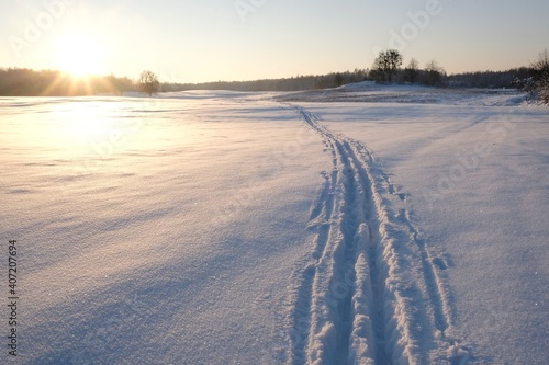 A snow-covered field perfectly lit by the setting sun