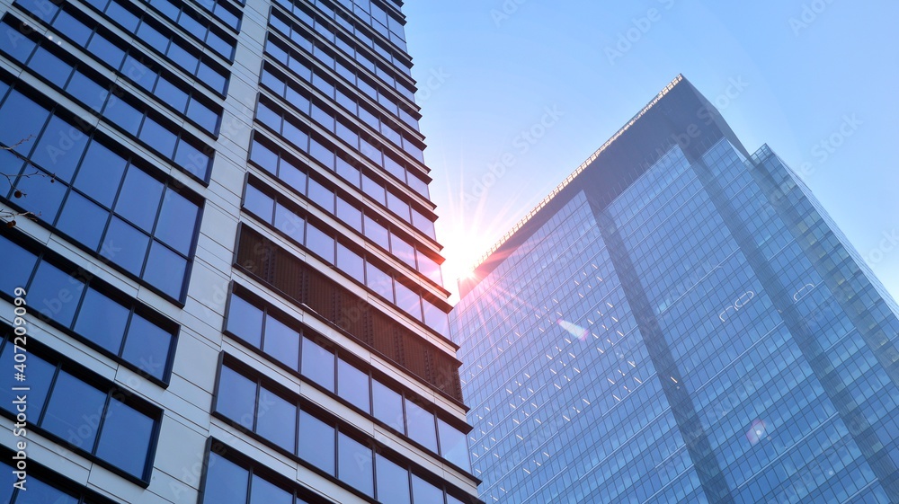 Concept for real estate and corporate construction..The modern office building of the orange morning sun in the sky background. Concept for real estate and corporate construction..The modern office building of the orange morning sun in the sky background.