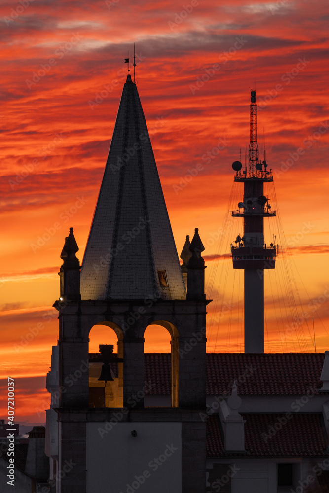Obraz premium Telecommunications tower and church silhouette in Abrantes Portugal