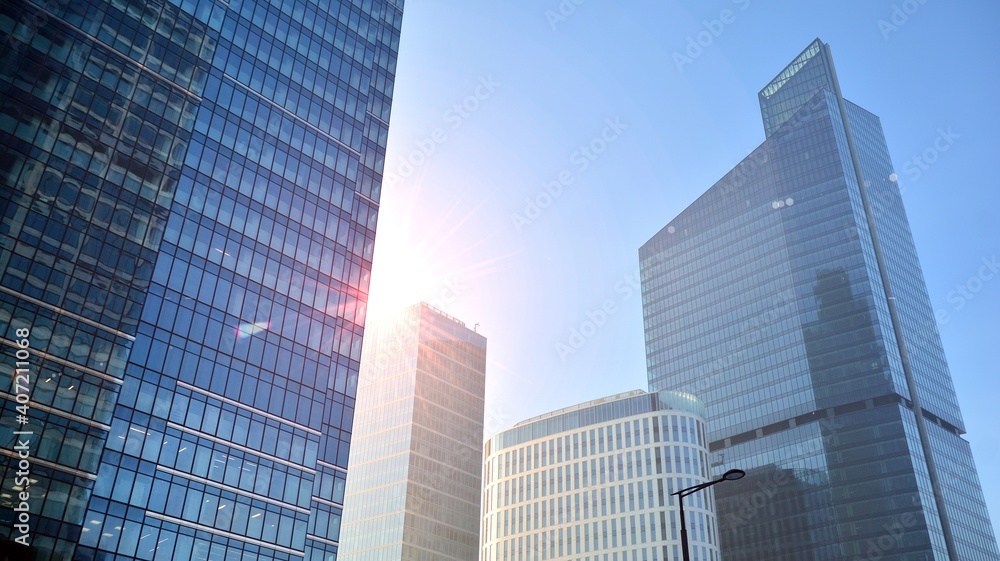 Concept for real estate and corporate construction..The modern office building of the orange morning sun in the sky background. Concept for real estate and corporate construction..The modern office building of the orange morning sun in the sky background.