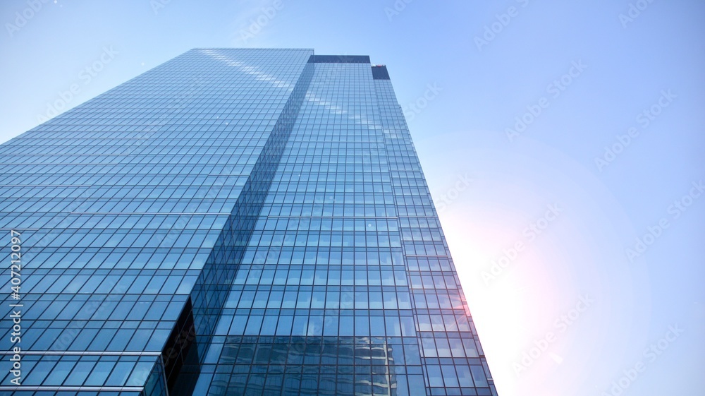 Concept for real estate and corporate construction..The modern office building of the orange morning sun in the sky background. Concept for real estate and corporate construction..The modern office building of the orange morning sun in the sky background.