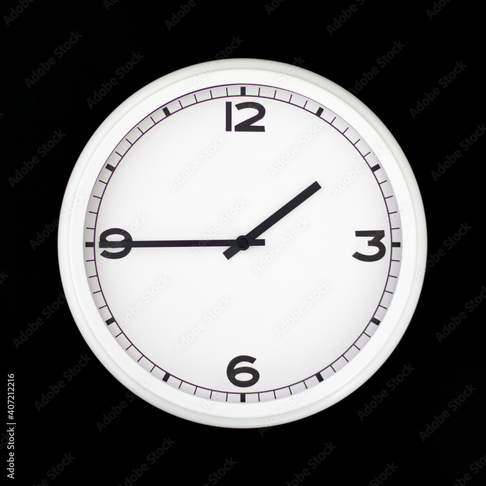 White round analog wall clock isolated on black background. White round analog wall clock isolated on black background.