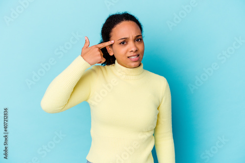 Young african american mixed race woman isolated showing a disappointment gesture with forefinger.