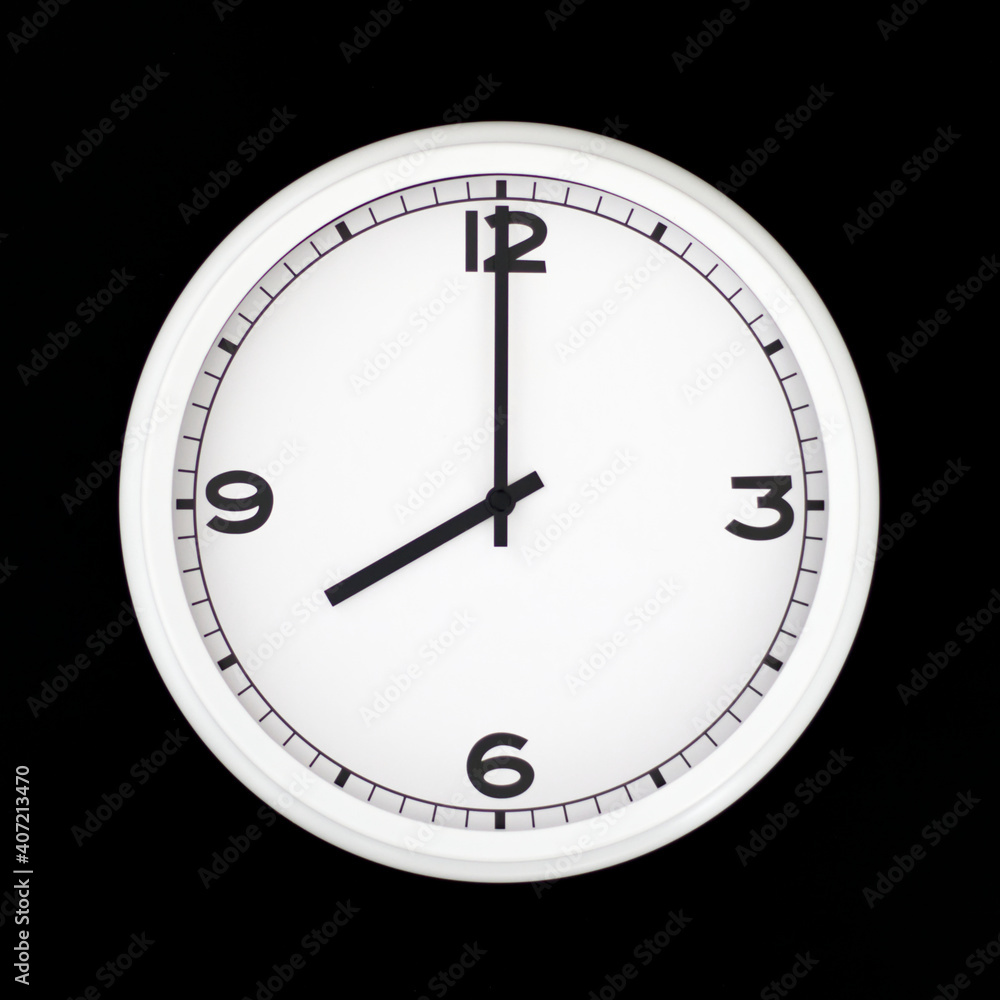 White round analog wall clock isolated on black background.