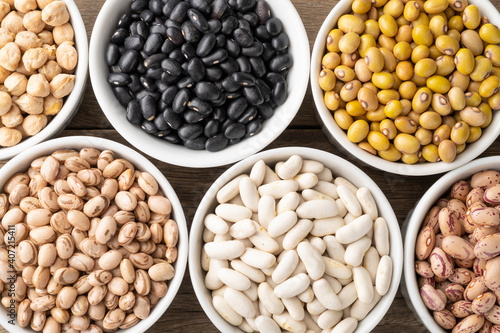 Closeup of assorted beans on white bowls
