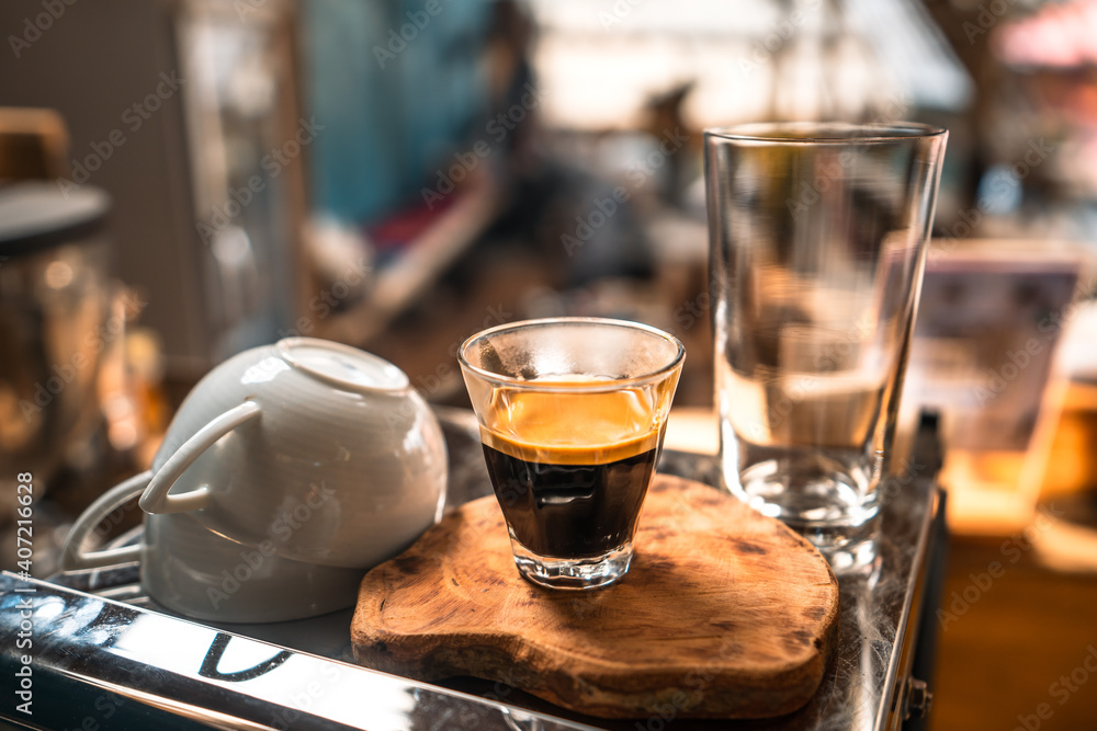 Espresso coffee is flowing into the shot cup. Espresso coffee is flowing into the shot cup.