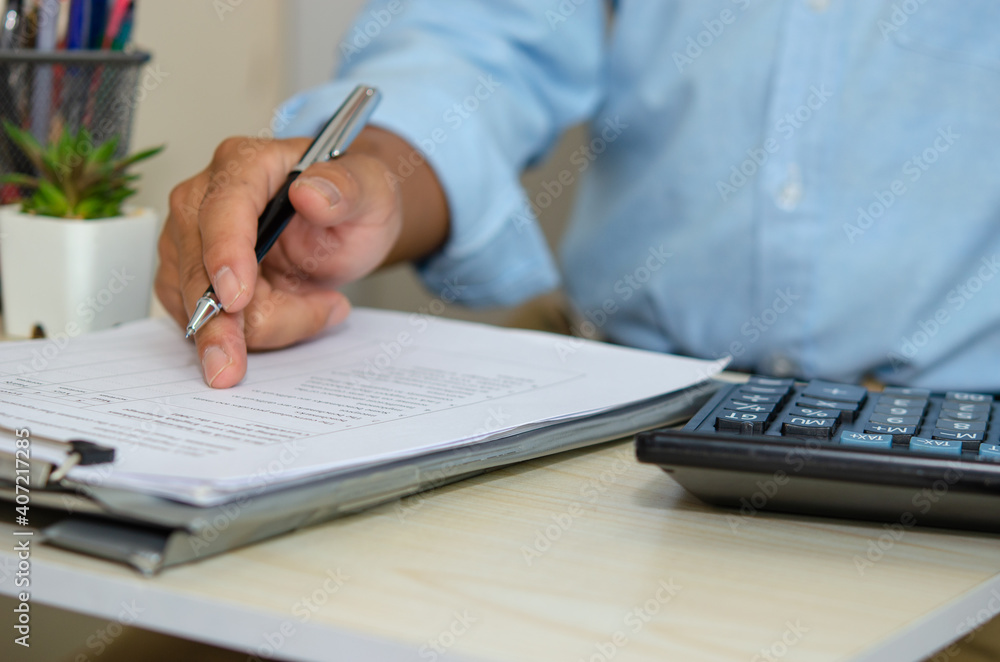 Business men look at business documents and hold pens at desk. Work from home Business men look at business documents and hold pens at desk. Work from home
