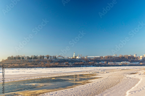 panorama of the frozen river and city on a cold winter day