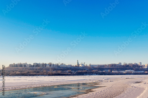 panorama of the frozen river and city on a cold winter day