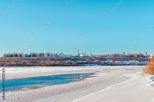 panorama of the frozen river and city on a cold winter day © Alx_Yago