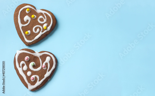 Two gingerbread cookies on a blue background, dessert as a gift, copy space for text