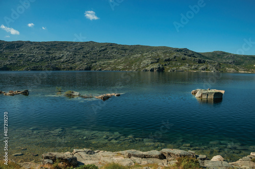 Fresh water at the Long Lake on highlands covered by bushes and rocks, at the Serra da Estrela. The highest mountain range in continental Portugal.