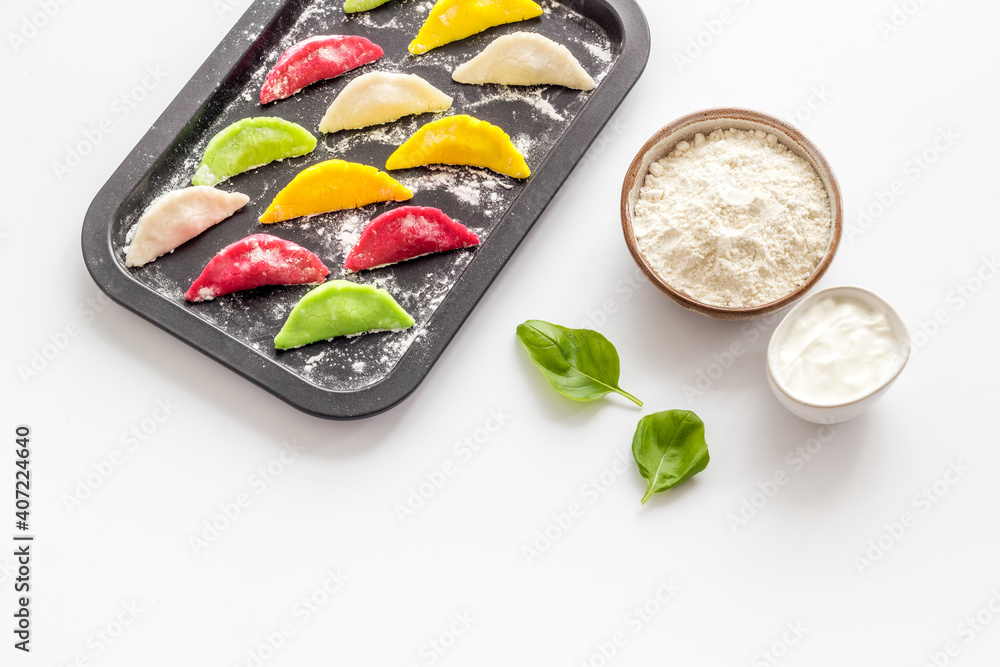 Chinese colorful raw dumplings on baking sheet, top view Chinese colorful raw dumplings on baking sheet, top view