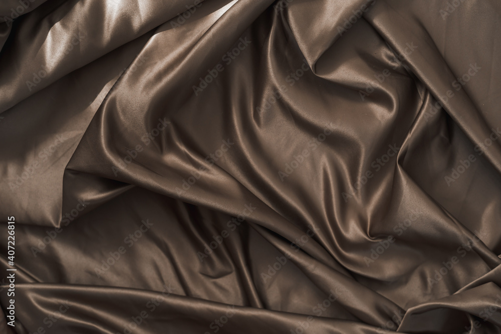 Fototapeta premium Brown atlas or silk fabric background, texture.