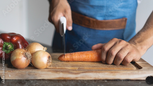 man cuts vegetables with his hands
