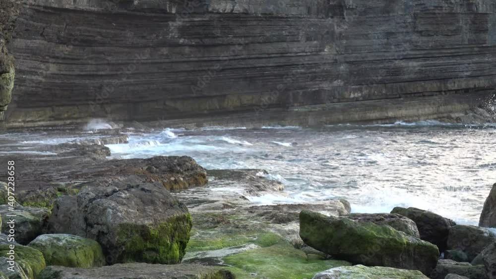 Waves beating the cliff in the evening Waves beating the cliff in the evening