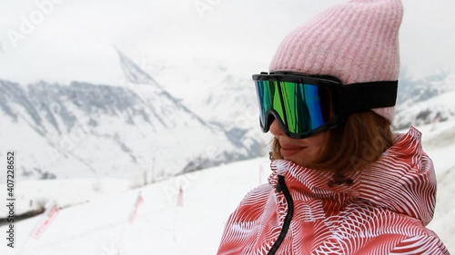 Portrait of a woman who is preparing for a descent in the mountains free ride. Skiing. Snowboard.