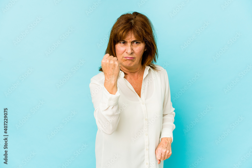 Senior caucasian woman isolated showing fist to camera, aggressive facial expression. Senior caucasian woman isolated showing fist to camera, aggressive facial expression.