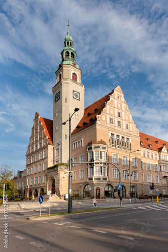 A beautiful building of the town hall with a magnificent tower in the city center of Olsztyn in Warmia, Poland against the background of a blue sky during the day