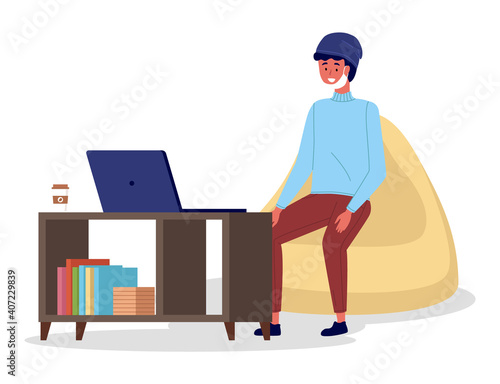 Young man in medical face mask sitting at a table in room and correspondence surfing the Internet. Male character communicating through network on the laptop. Freelance, work from home and home office