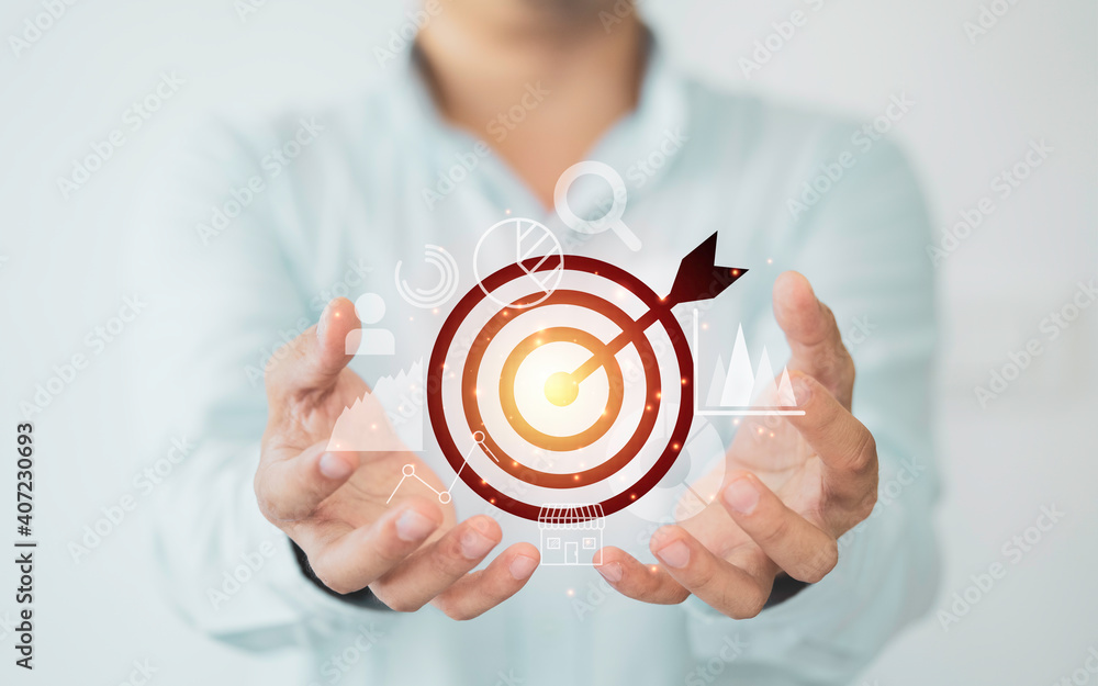 Businessman holding virtual dartboard with arrow ,Business Achievement objective target concept. Businessman holding virtual dartboard with arrow ,Business Achievement objective target concept.