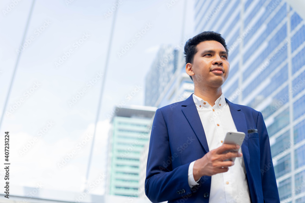 close up adult mixed race of middles eastern businessman holding smartphone and standing outside company over city building background for future vision concept close up adult mixed race of middles eastern businessman holding smartphone and standing outside company over city building background for future vision concept