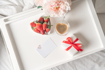 Spring, summer still life composition for valentine day. Blank greeting card mockup scene with heart shaped cup of coffee, strawberries, and roses flowers. Breakfast in bed. Flat lay, top view