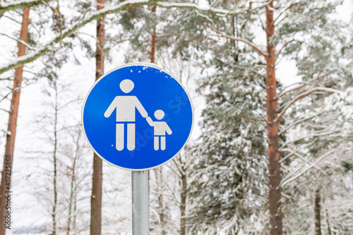 Blue sign parental supervision or walking area in the winter forest