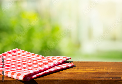 Cloth napkin on wood table with glass window background