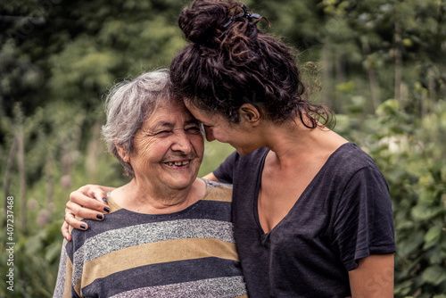 Young woman and her grandmother, very old woman. Two generations. Family love.