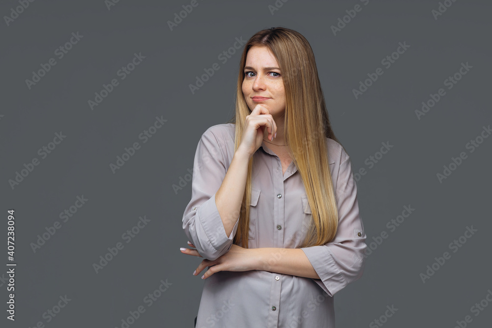 Portrait of dreamy cute lady, youth, people touch chin, think, choose, solve problems, wear fashionable clothes, isolated gray background Portrait of dreamy cute lady, youth, people touch chin, think, choose, solve problems, wear fashionable clothes, isolated gray background