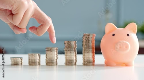 Closeup man hand finger step up on stacking coins, save money and growth concept photo