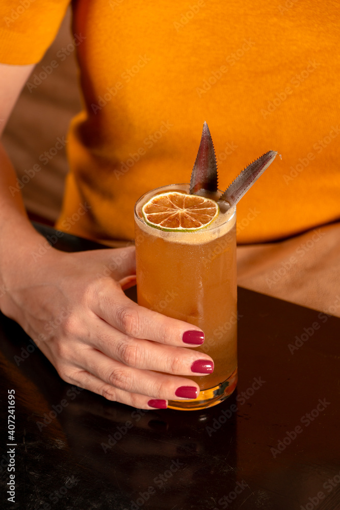 person drinking orange juice
